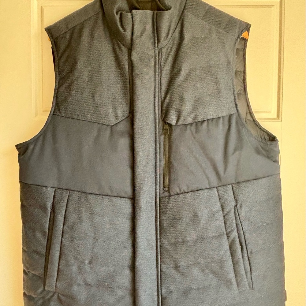 Tumi reversible navy and black down filled vest: Men's L